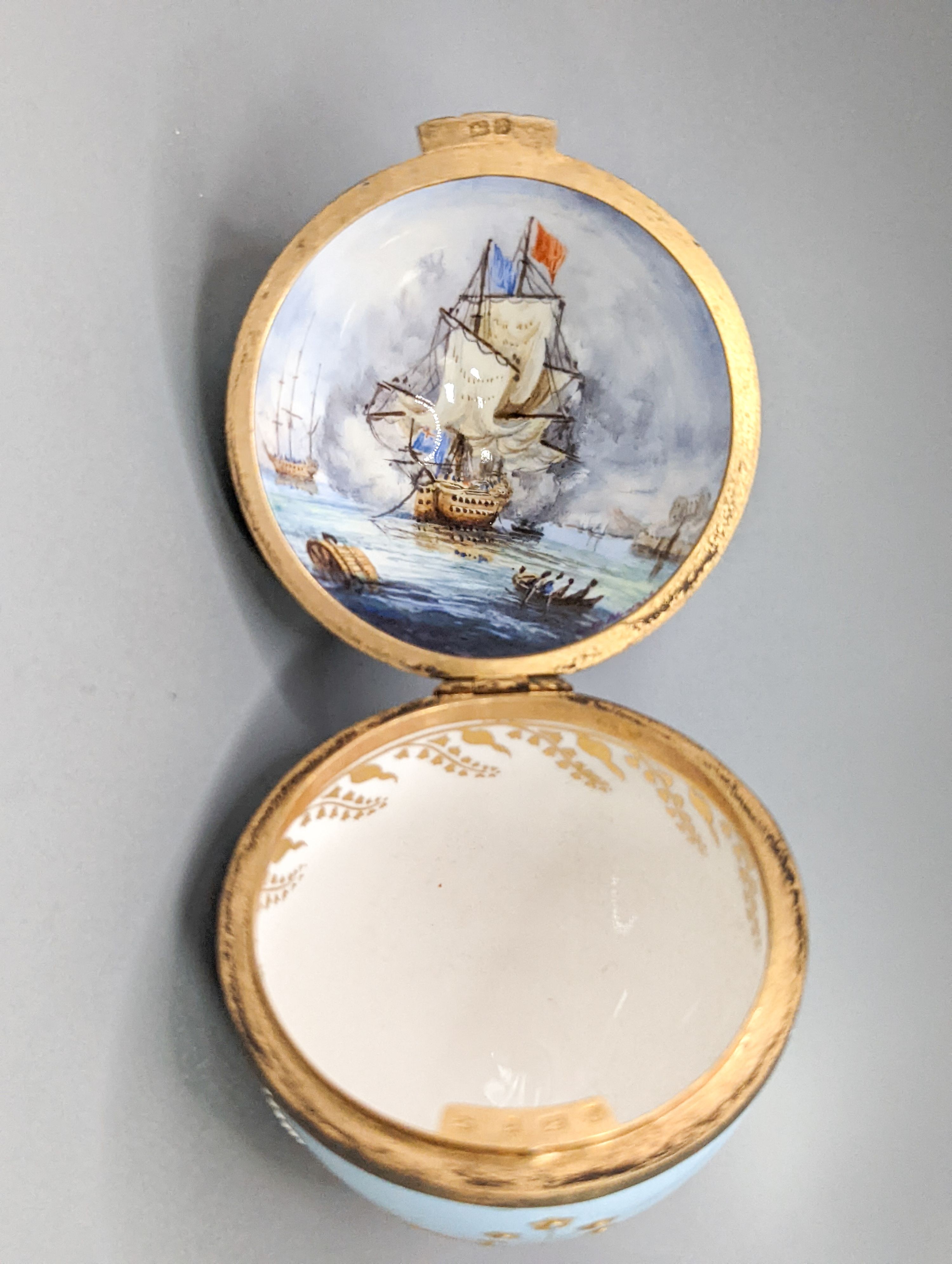 Two silver gilt mounted enamelled eggs with interior seascapes, on silver gilt stands, Birmingham, 1985 & 7 and a smaller similar gilt metal mounted zodiac egg, tallest 8.5cm